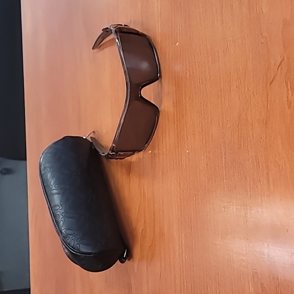 Brown Oakley sunglasses with soft black case